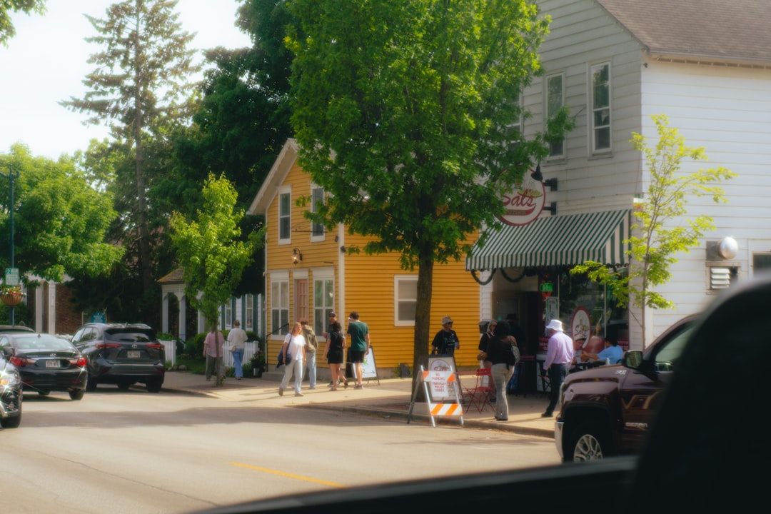 A group of friends walks down a quiet main street on a summer day trip from NYC by train