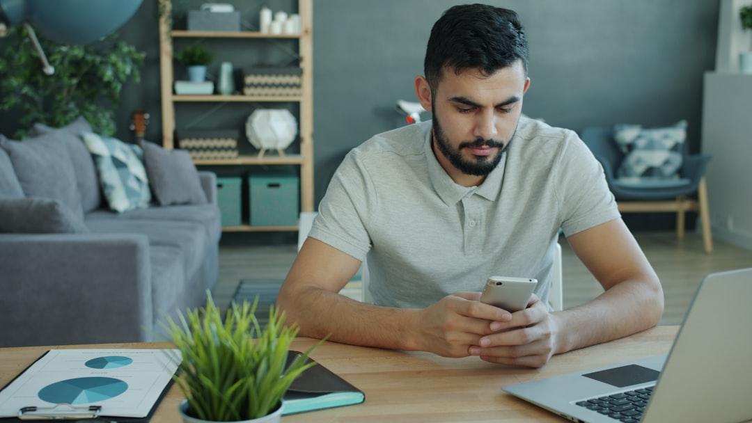 A man uses phone to calculate the long-term equity benefits of Brooklyn co-op ownership to rent in New York City.
