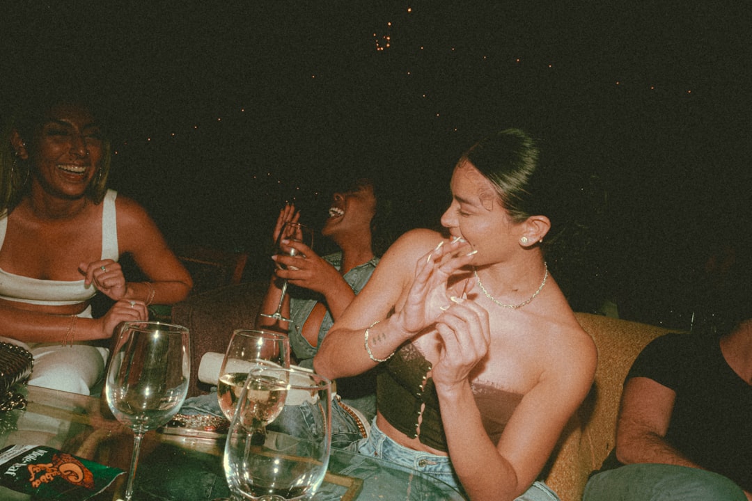 A group of friends sharing gluten-free dishes on a sunny outdoor patio in Brooklyn, New York