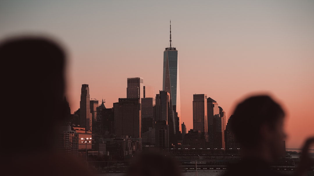 A group of professionals share an evening dinner on a rooftop terrace, reflecting the networking culture.
