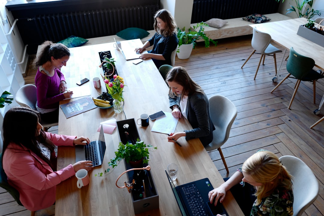 A diverse team holds a meeting in a bright co-working spaces NYC environment, surrounded by contemporary furniture.