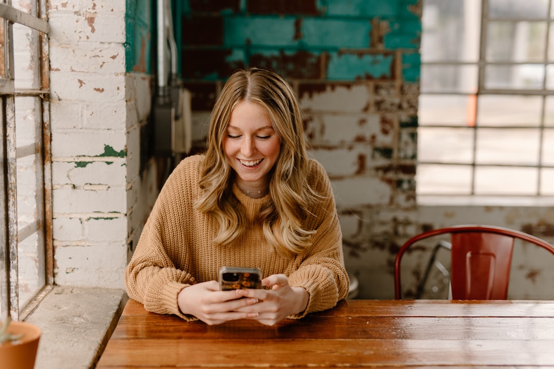 Woman drafting a Halloween email newsletter on her phone