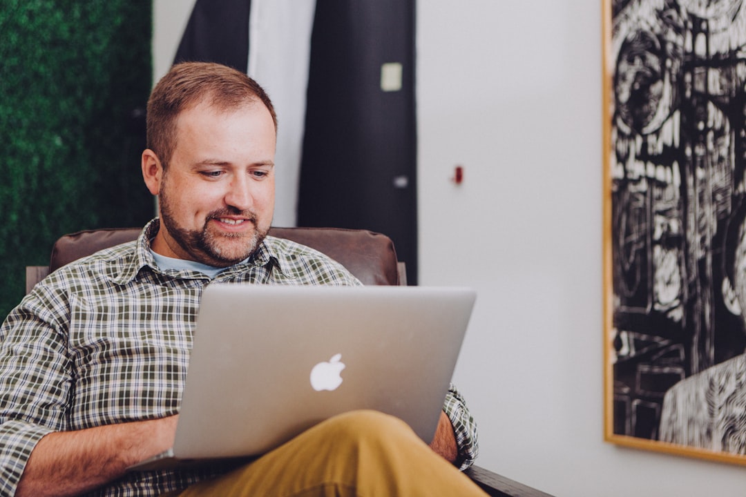 Shop owner reviewing referral program results on a laptop