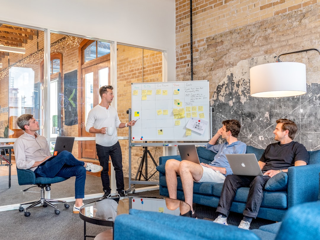 Small team discussing AI model choice around a whiteboard
