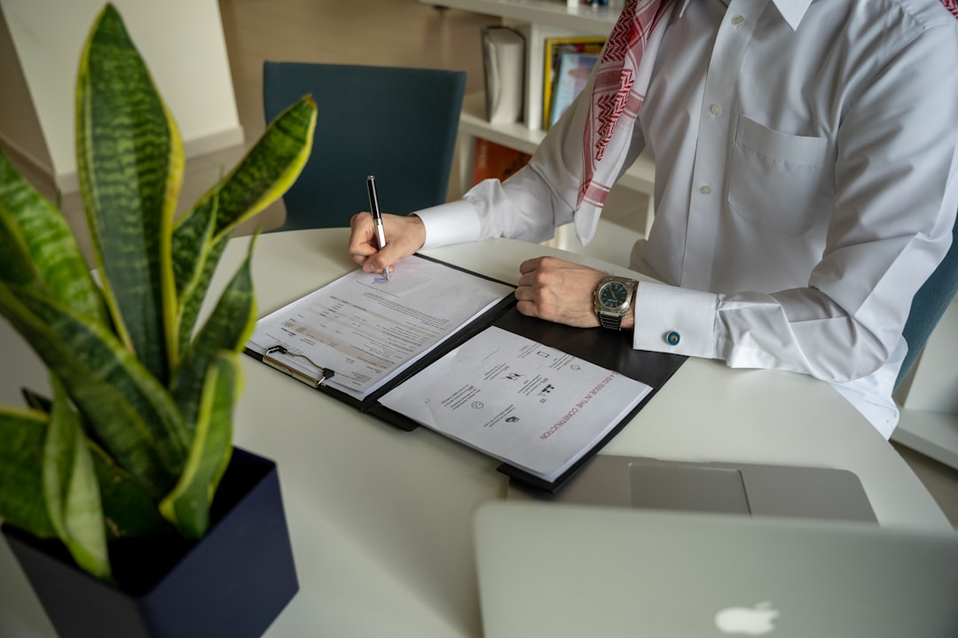 Small business owner reviewing vendor contracts at her desk