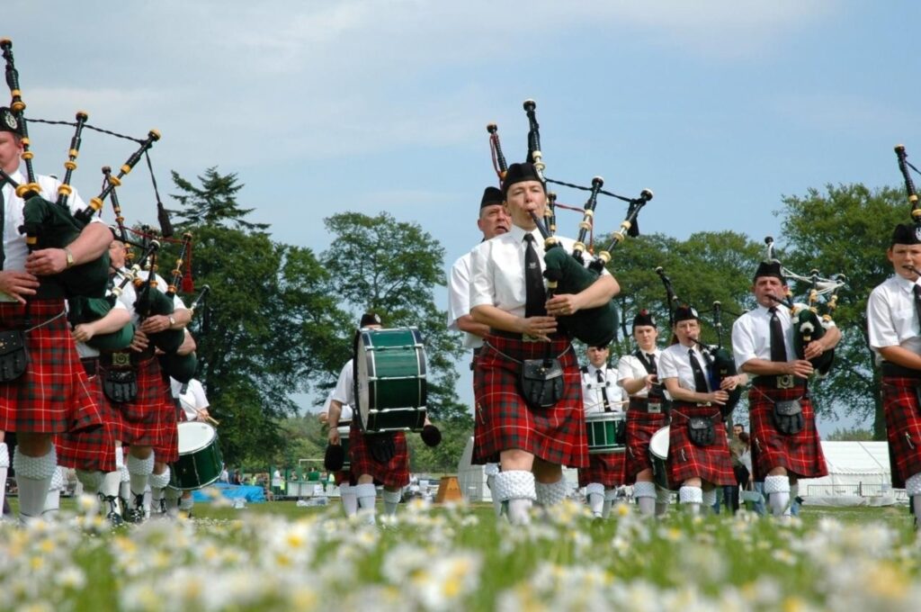Scottish Burns Night celebration with traditional bagpiper for haggis ceremony and cultural tradition