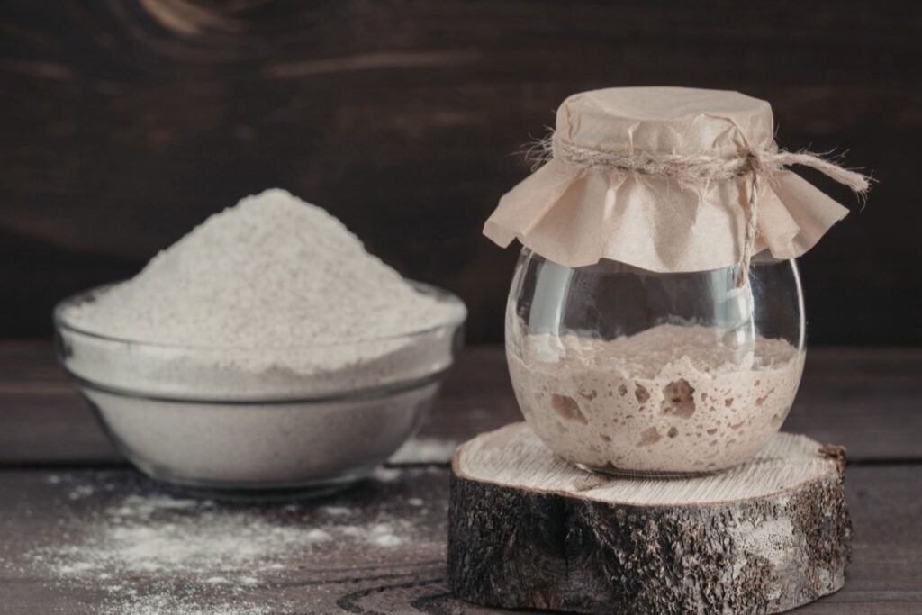 Sourdough bread starter showing active wild yeast fermentation with bubbles for artisan baking