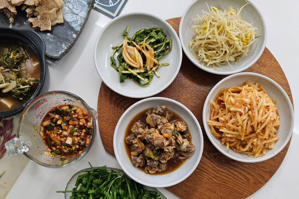 _A traditional Korean banchan spread with kimchi, pickled radish, and spinach namul side dishes