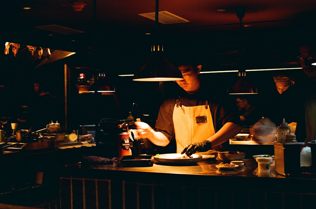 A chef plates a refined dish featuring kimchi as a key ingredient, showing howkimchi has reached fine menus around the world.
