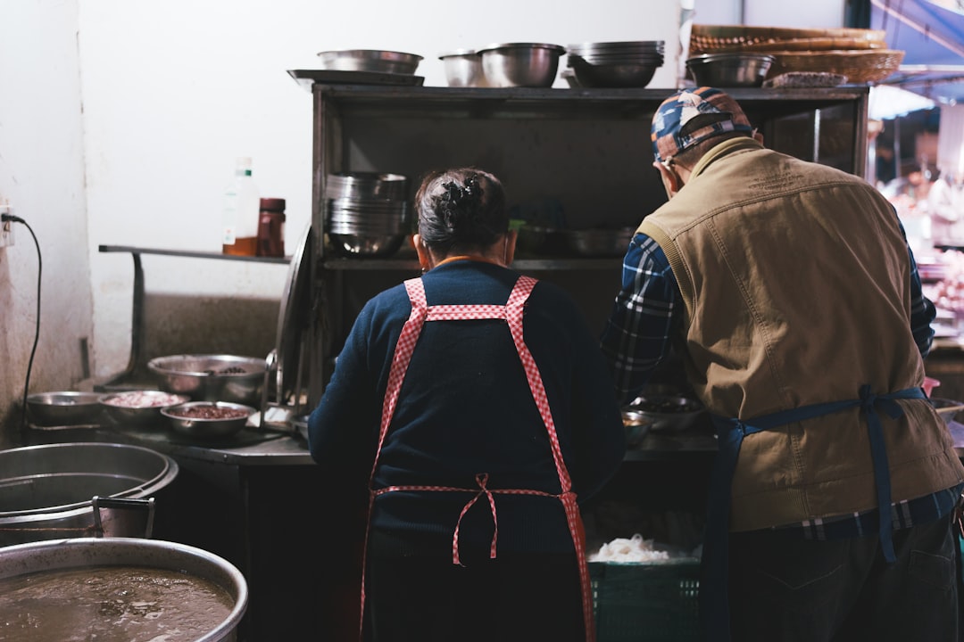 A chef speaks with a local farmer at an outdoor market, illustrating the honest narrative of tasting menus.