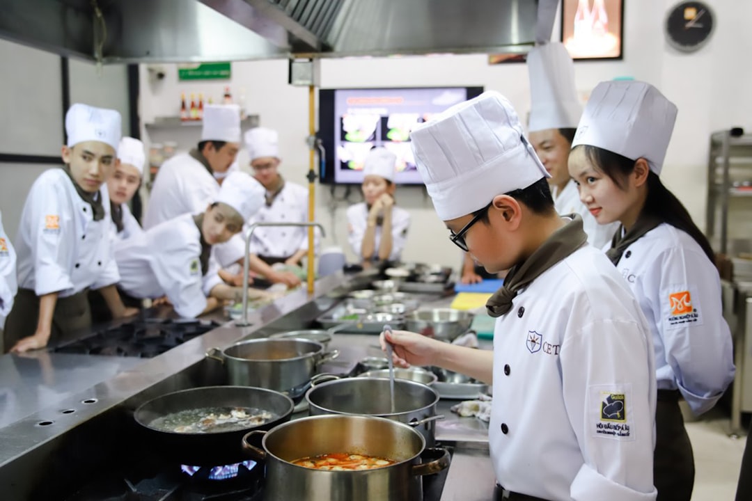 A group of chefs work together in a professional kitchen, reflecting the sustainability principles