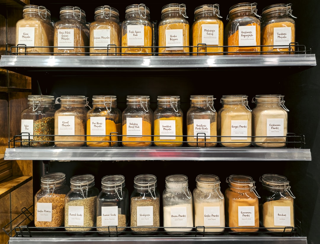 A cook organises pantry jars of dried mushrooms, kombu, and soy sauce, for building deep flavour in any meatless recipe.