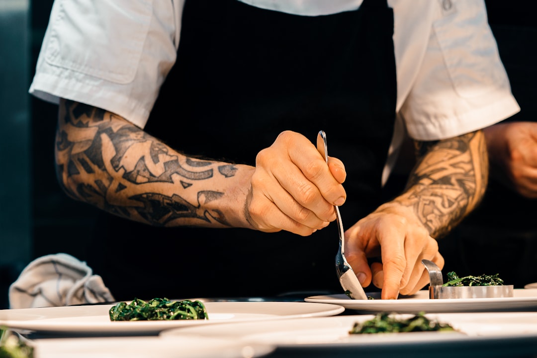 A young chef plates a dish at a culinary competition, representing the next generation of talent driving the future