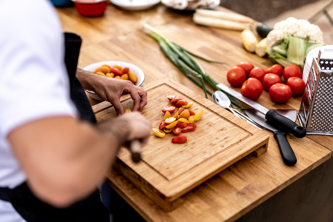 A chef tasting freshly prepared kimchi in a traditional kitchen, illustrating how fermentation remains central.