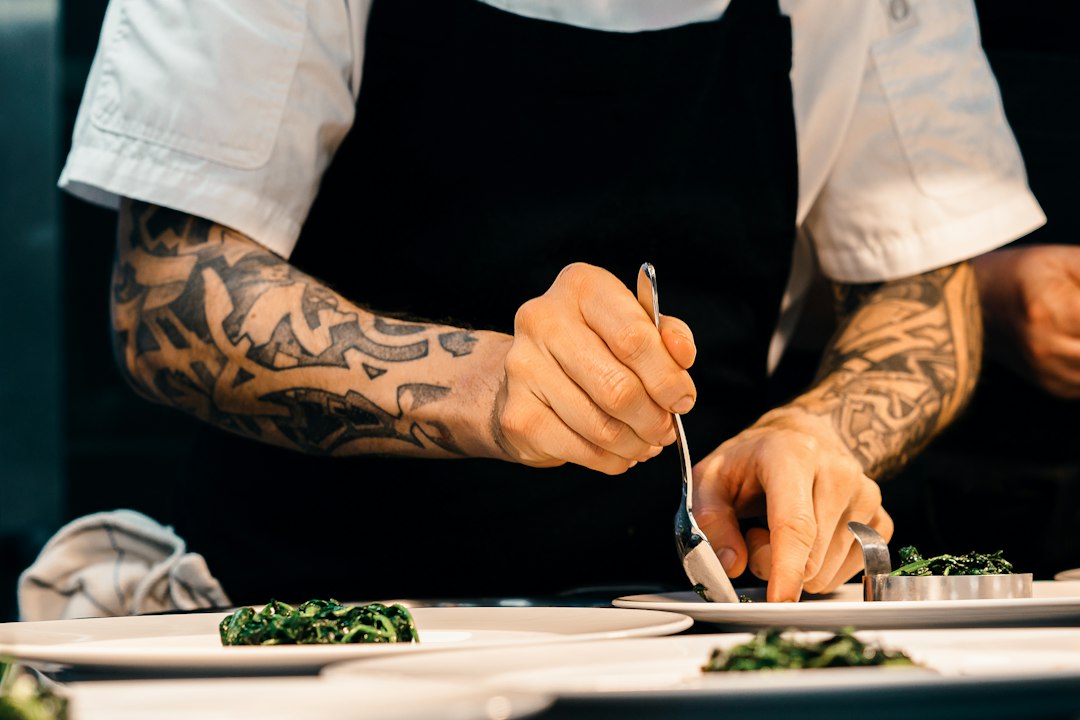 A professional chef plating a braised autumn dish, capturing what the autumn equinox brings to the northern hemisphere table