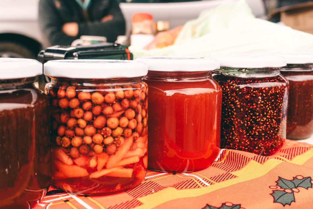 A market vendor displaying rows of jarred fermented foods, reflecting the enduring global tradition of fermentation.
