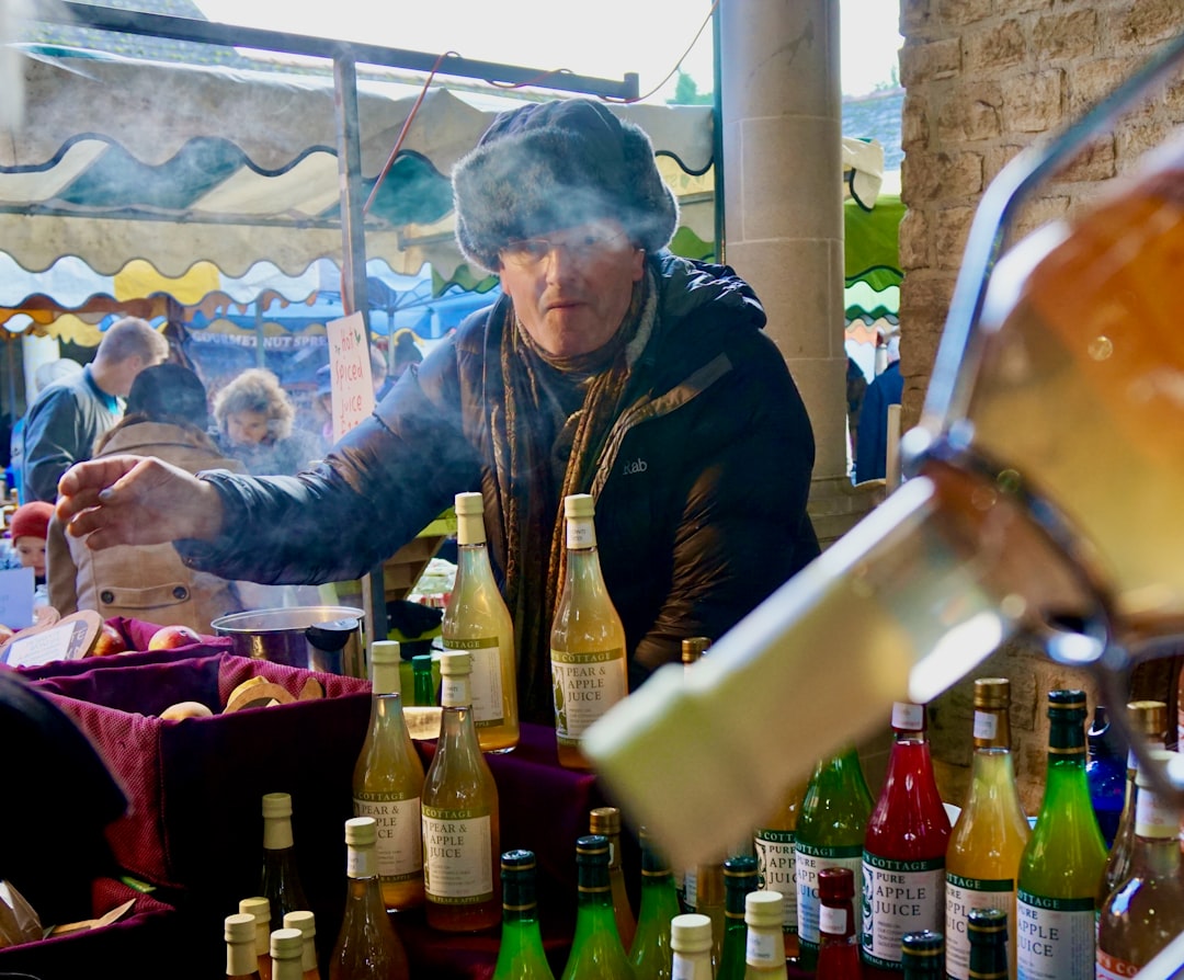 A person wraps both hands around a cup of warm spiced drinks at a winter market, reflecting the deep European tradition.