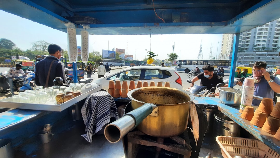 A chai vendor pours warm spiced drinks on a busy Indian street, a daily ritual rooted in centuries of spice culture.