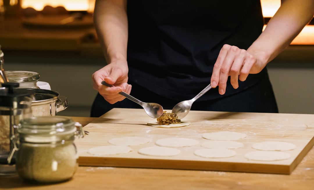 A woman prepares a wild mushroom tart at home, one of several elegant autumn dishes built around fresh seasonal produce