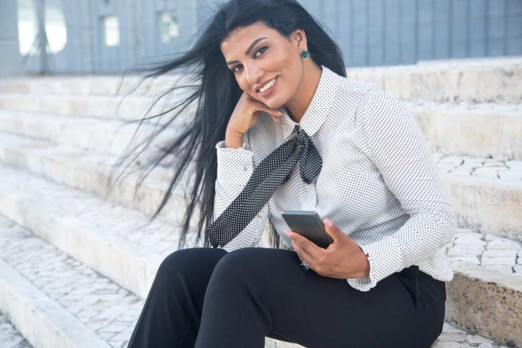 Smiling stylish businesswoman looking at camera