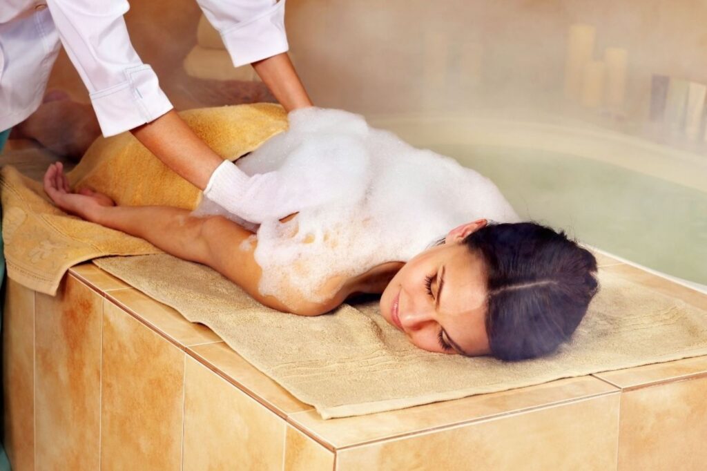 Traditional Moroccan hammam steam bath ritual for setting mindful intentions through purification ceremony using black soap, Rhassoul clay, and argan oil representing wellness approach for 2026 transformation