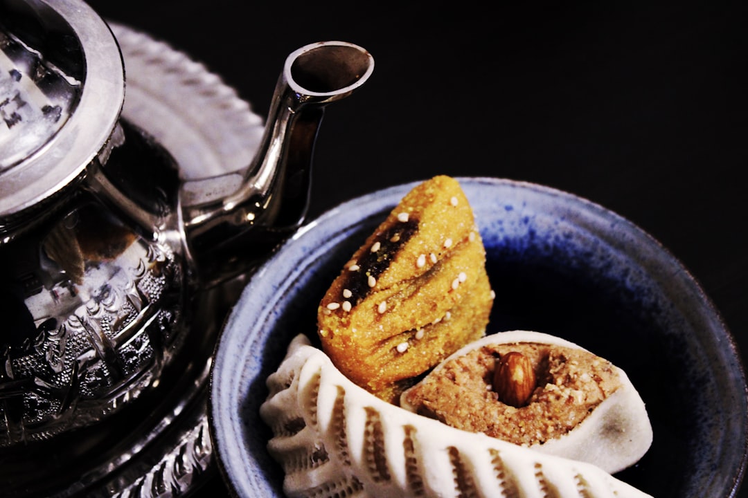 A woman shaping almond ghriba cookies as part of her naturally gluten-free Moroccan dishes routine