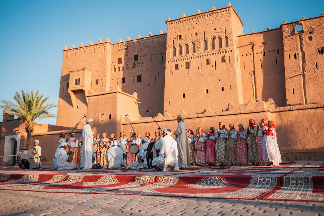 Visitors watching a traditional dance performance at the popular arts festival in Marrakech's historic El Badi Palace
