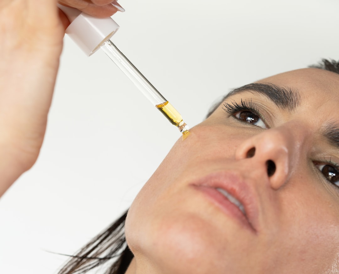 A woman applying argan oil to her face as part of a traditional morning wellness ritual