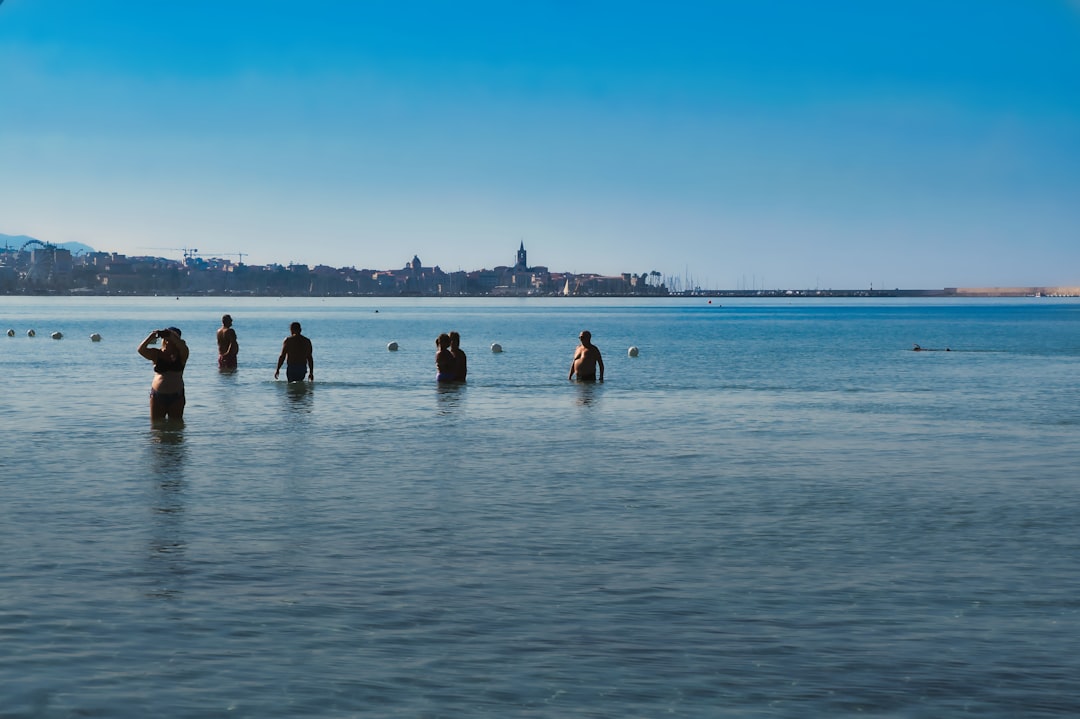 A group of women stand together at the edge of the Atlantic, ready for a shared session of cold water swimming