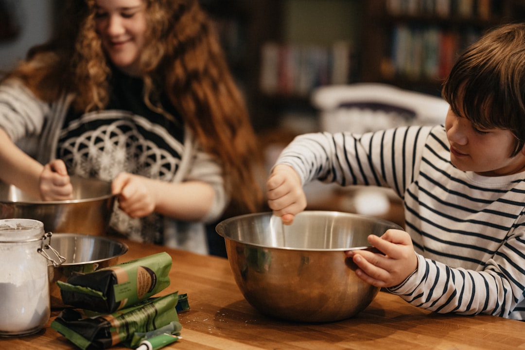 A woman and her child preparing tagine in a Moroccan kitchen, learning Moroccan Arabic names for spices and utensils