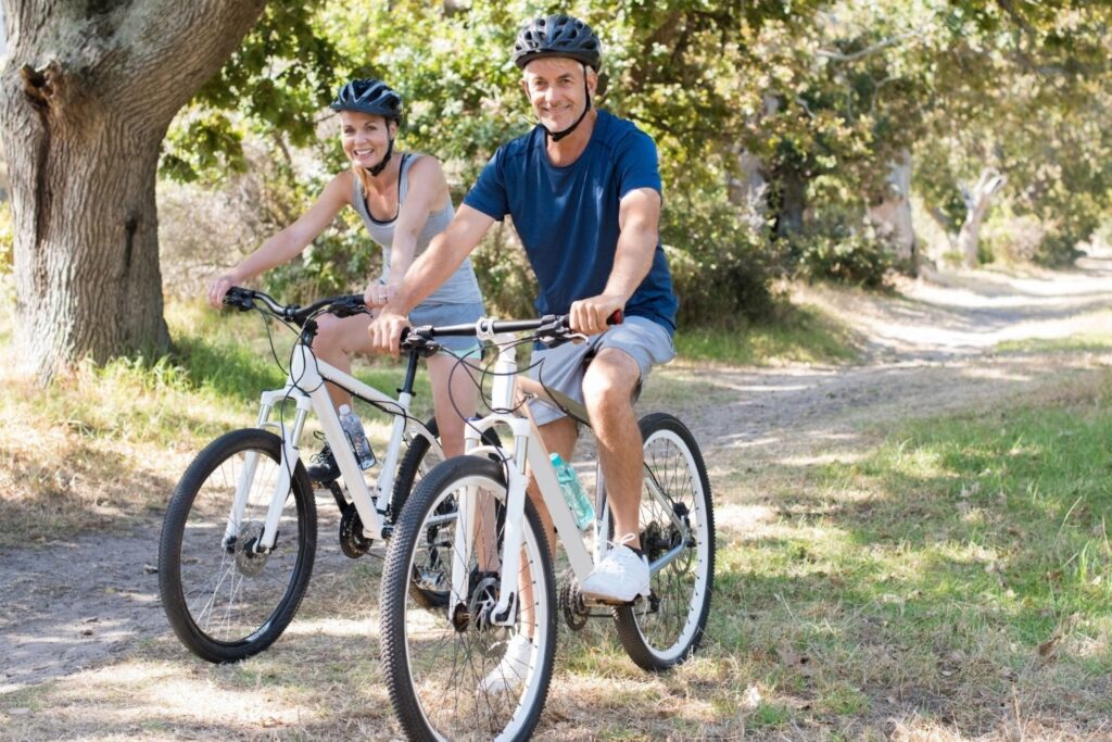 healthy couple cycling together in Dubai park outdoor fitness training parks morning