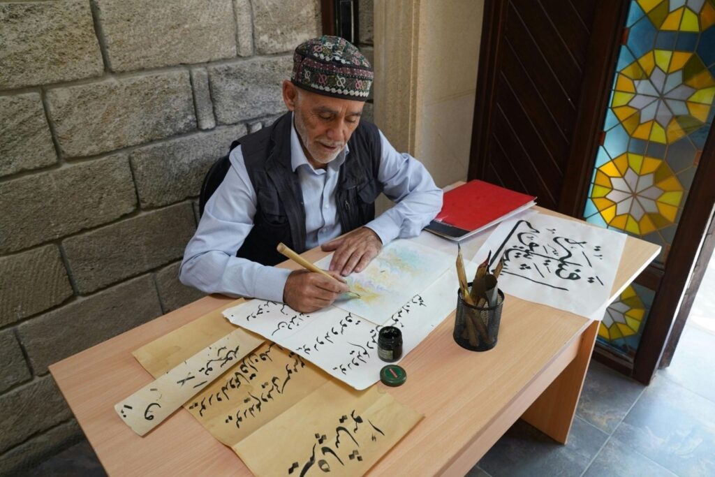 Artist practicing Arabic calligraphy in traditional workshop art workshops creative studio classes
