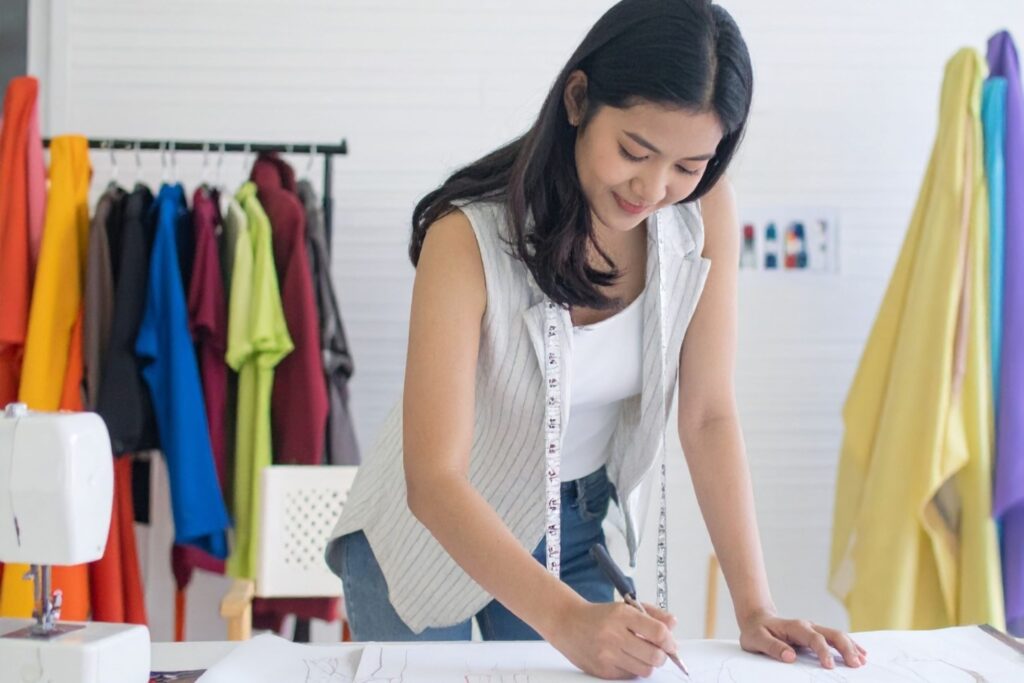 Fashion designer working with sustainable fabrics in studio ethical fashion sustainable boutiques eco luxury