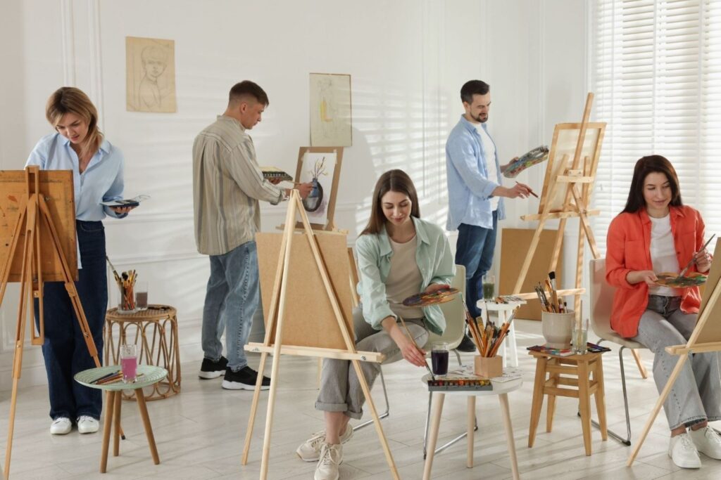 Group of people enjoying painting class together in studio art workshops creative classes painting