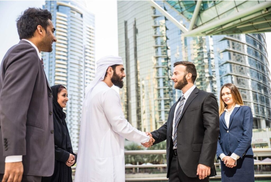 International business handshake meeting outside Dubai towers startup ecosystem entrepreneurs funding innovation investment