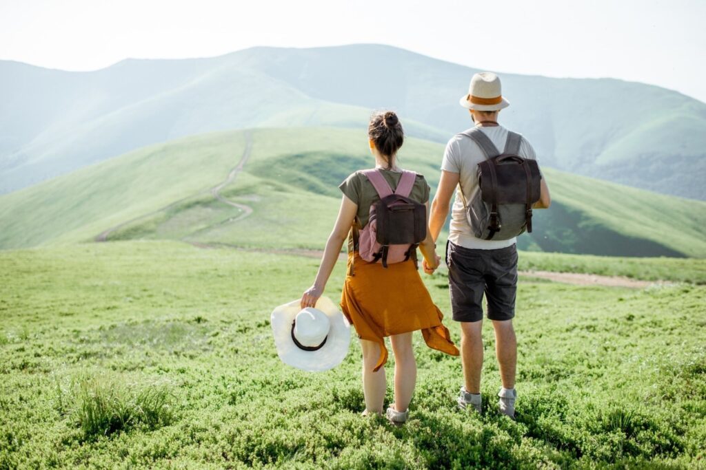 Couple hiking in Caucasus mountains Georgia weekend escapes adventure travel destination flight