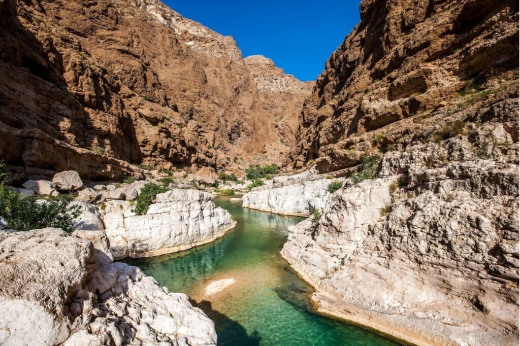 Crystal clear turquoise pools at Wadi Shab Oman road trip adventure wadi drive