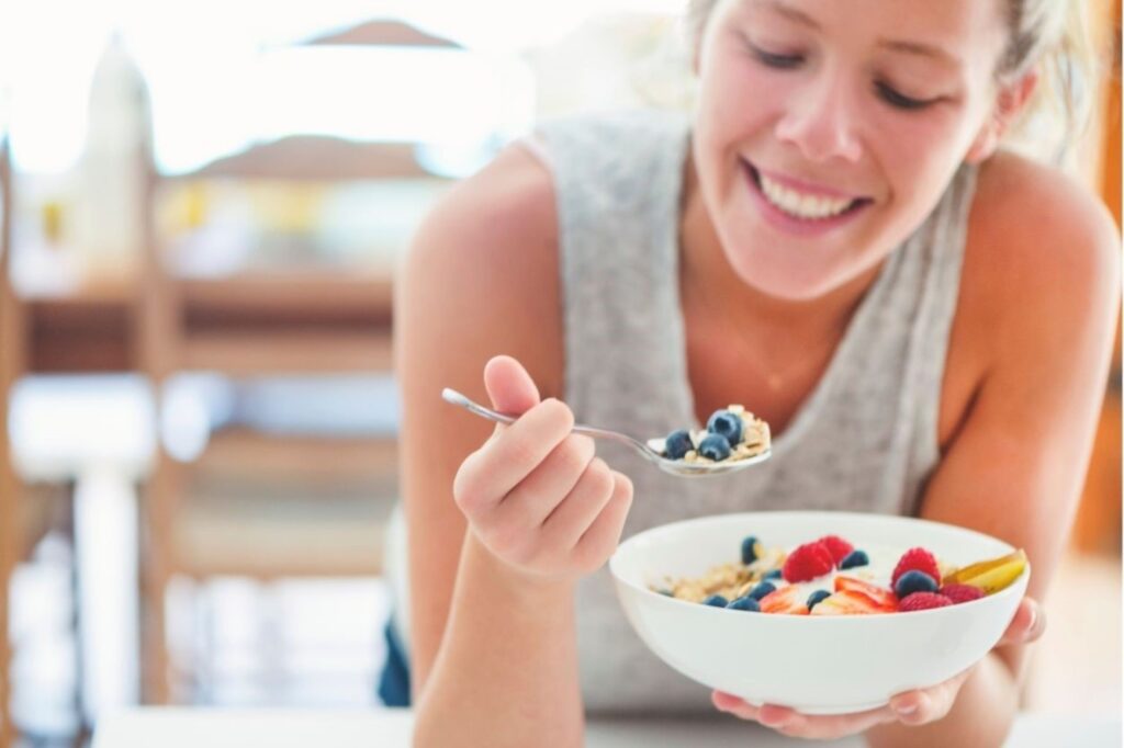 Woman enjoying gluten-free breakfast at Dubai wellness cafe gluten-free breakfast healthy nutritious recipe