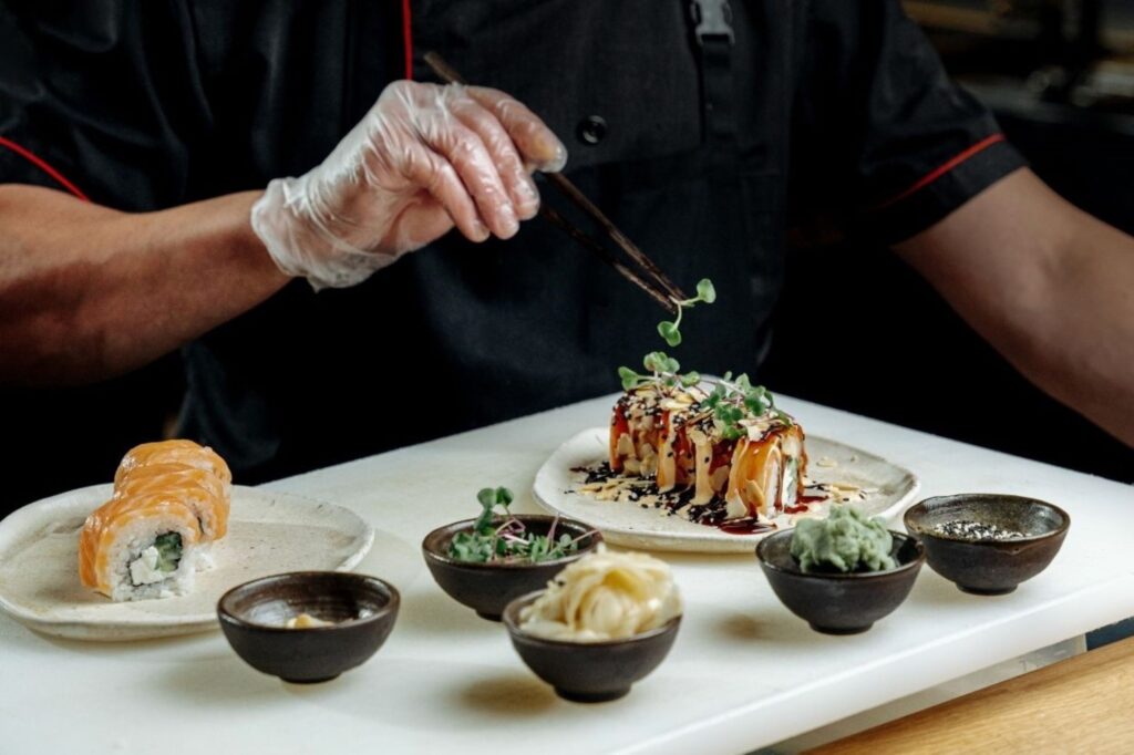 Beautifully presented gourmet tasting menu dish from Dubai culinary legends' Michelin-starred restaurant, showcasing innovative signature cuisine and exceptional plating artistry from celebrity chefs