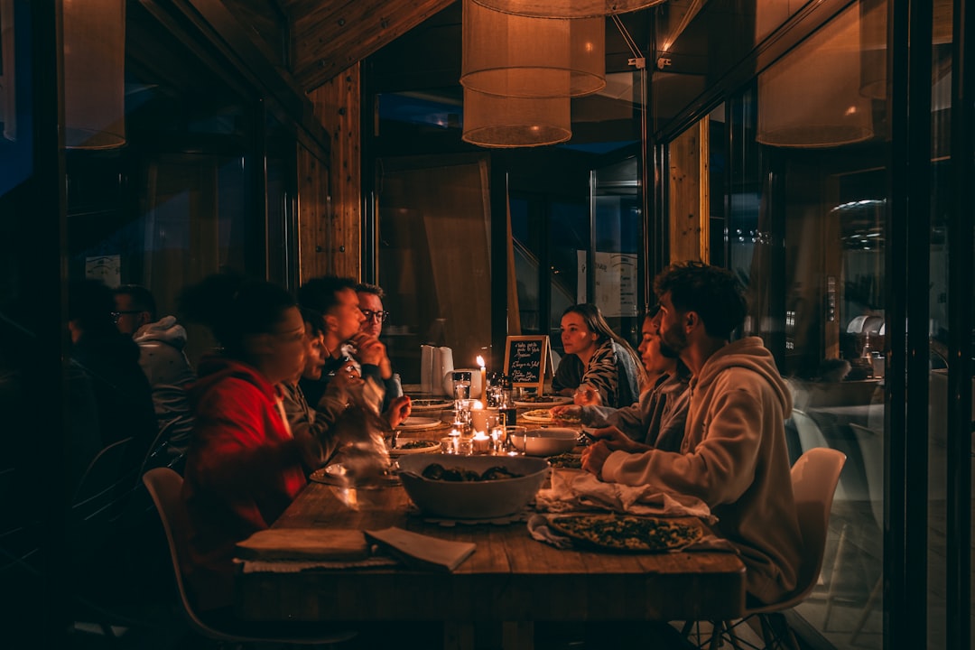 A group of friends sharing dishes together at a summer brunch in Dubai, with colourful plates and drinks on the table