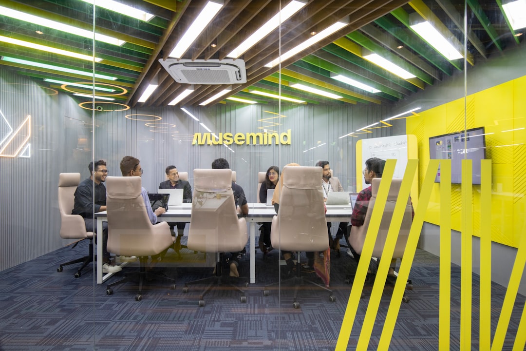 A diverse team of entrepreneurs in a Dubai coworking space discussing startup growth, reflecting Dubai liveability