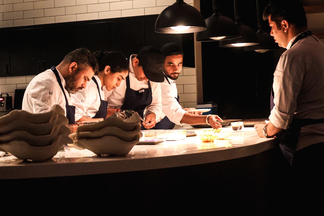 A group of friends sharing dishes from a summer restaurant week menu at an indoor Dubai venue