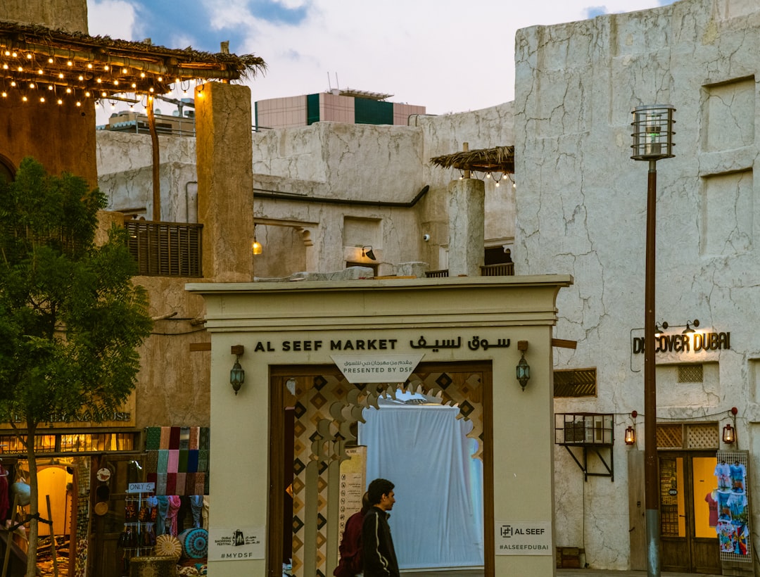 A woman exploring the historic streets of Old Dubai, where expat communities have shaped the character of every neighbourhood