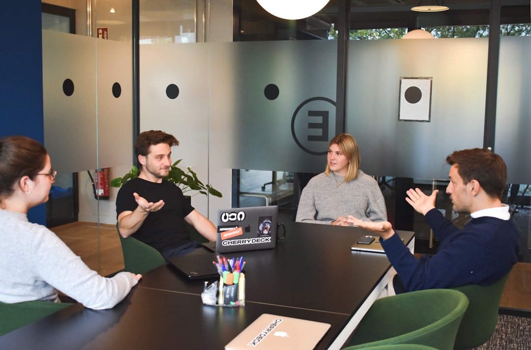 A startup founder discussing private equity funding options with her team in a modern Dubai workspace