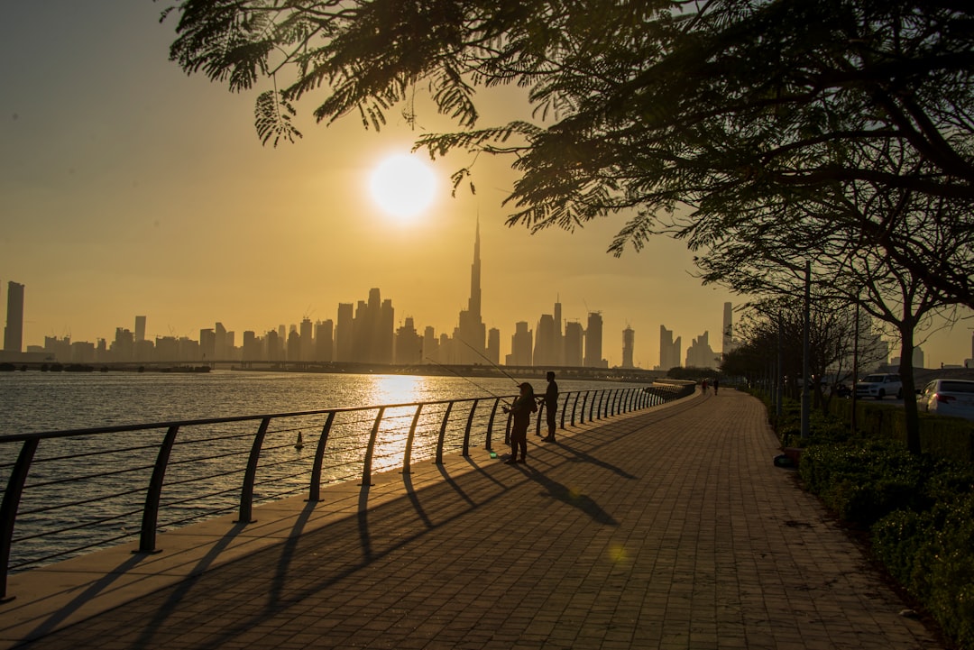 A group of friends walking along the beach at sunset, embracing the renewed social life in Dubai as the cooler season begins