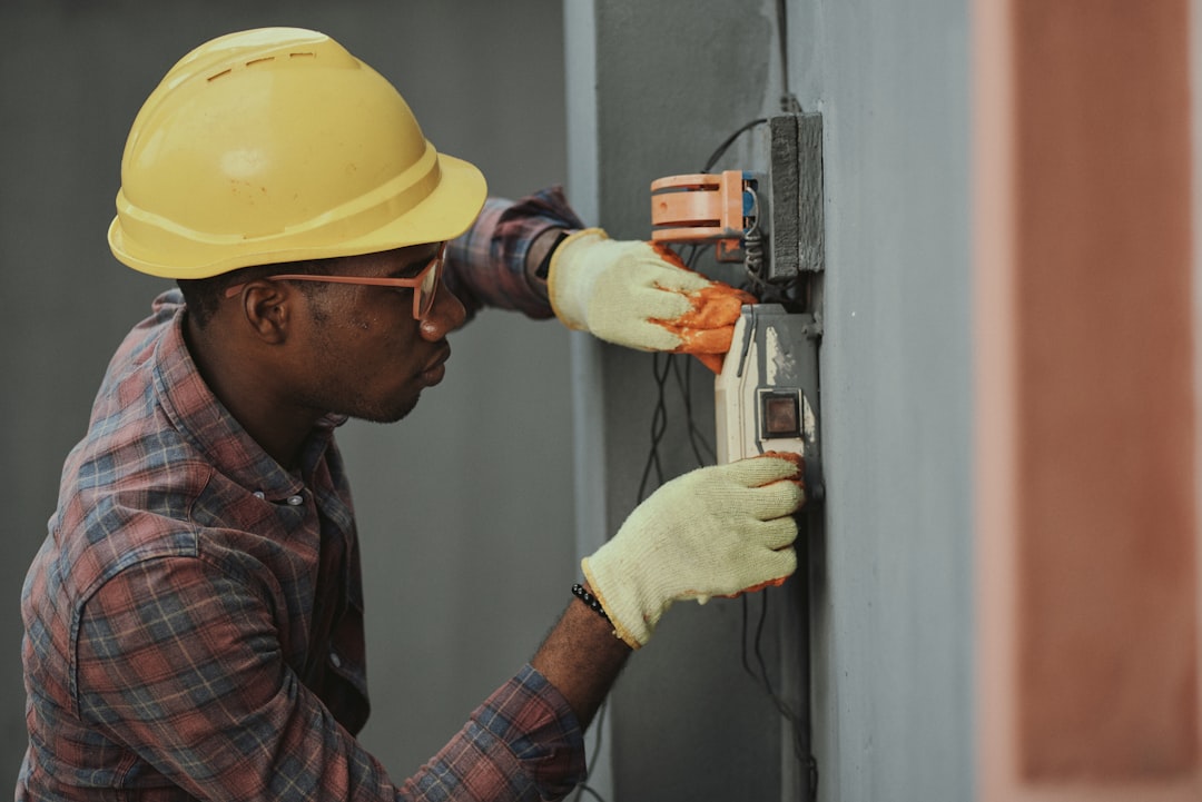 A technician cleaning an AC filter inside a Dubai home, a key step in managing cooling costs and keeping the system running.