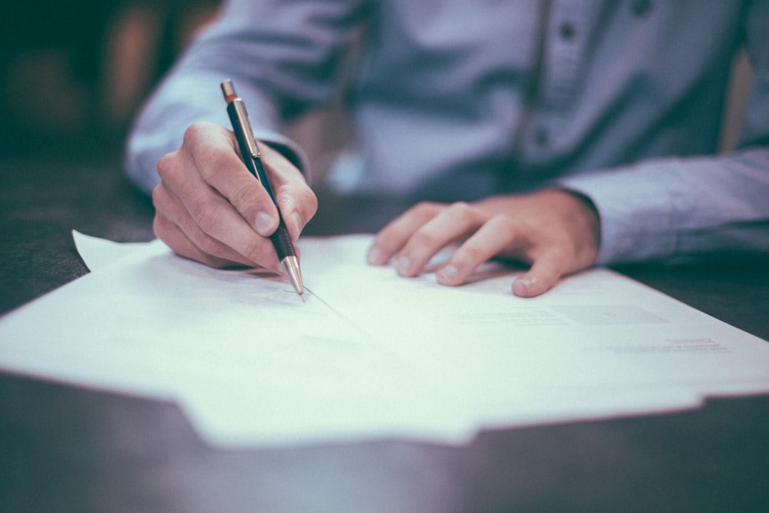 A man completing brokerage account paperwork to begin trading Dubai REITs on the DFM