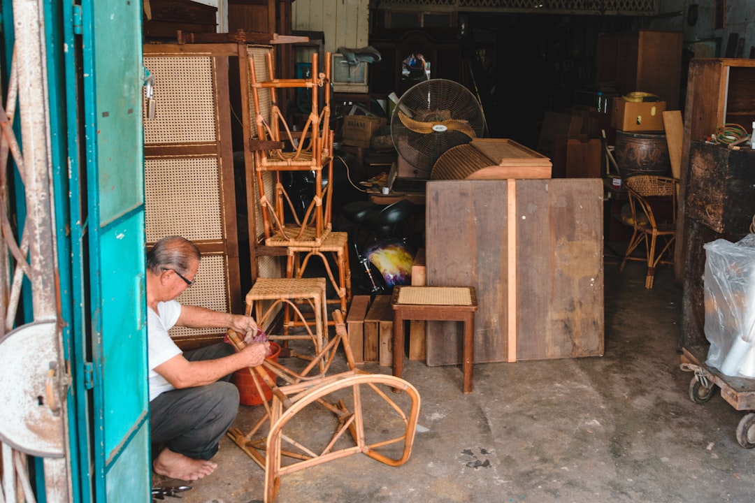 A man sanding wood at a maker space bench, representing the hands-on learning experience available at Dubai studios