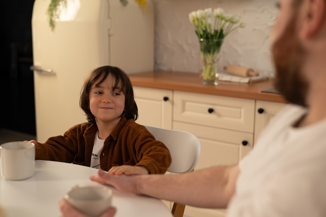 A parent and child sitting together at a table having a calm conversation to prepare emotionally for the school term in Dubai