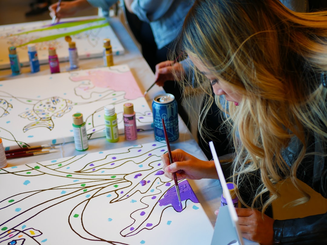 people painting together on canvas in a creative workshop in Dubai